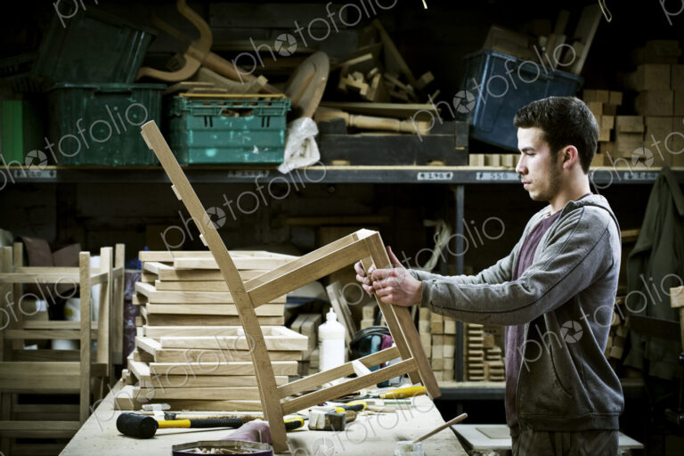 A man working in a furniture maker's workshop.