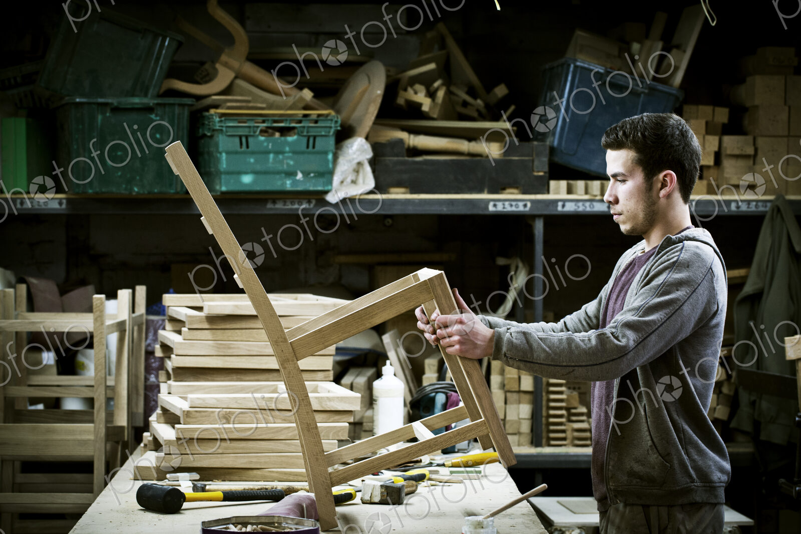 A man working in a furniture maker’s workshop.