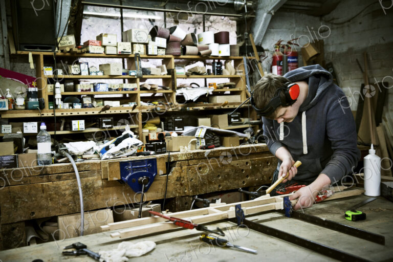 A man working in a furniture maker's workshop.