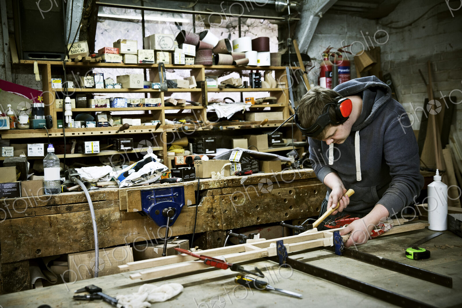 A man working in a furniture maker’s workshop.