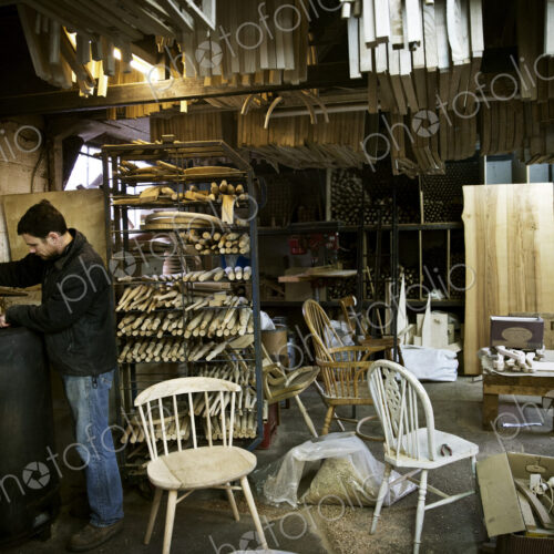 A man working in a furniture maker's workshop. Windsor chairs. A man working in a furniture maker's workshop. Windsor chairs.