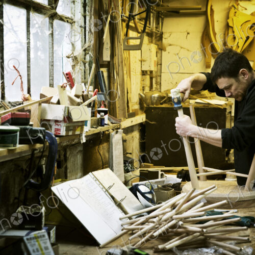 A man working in a furniture maker's workshop. Windsor chairs. A man working in a furniture maker's workshop. Windsor chairs.