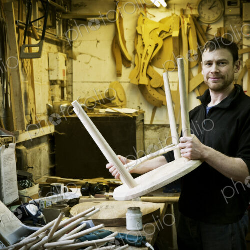 A man working in a furniture maker's workshop. Windsor chairs. A man working in a furniture maker's workshop. Windsor chairs.
