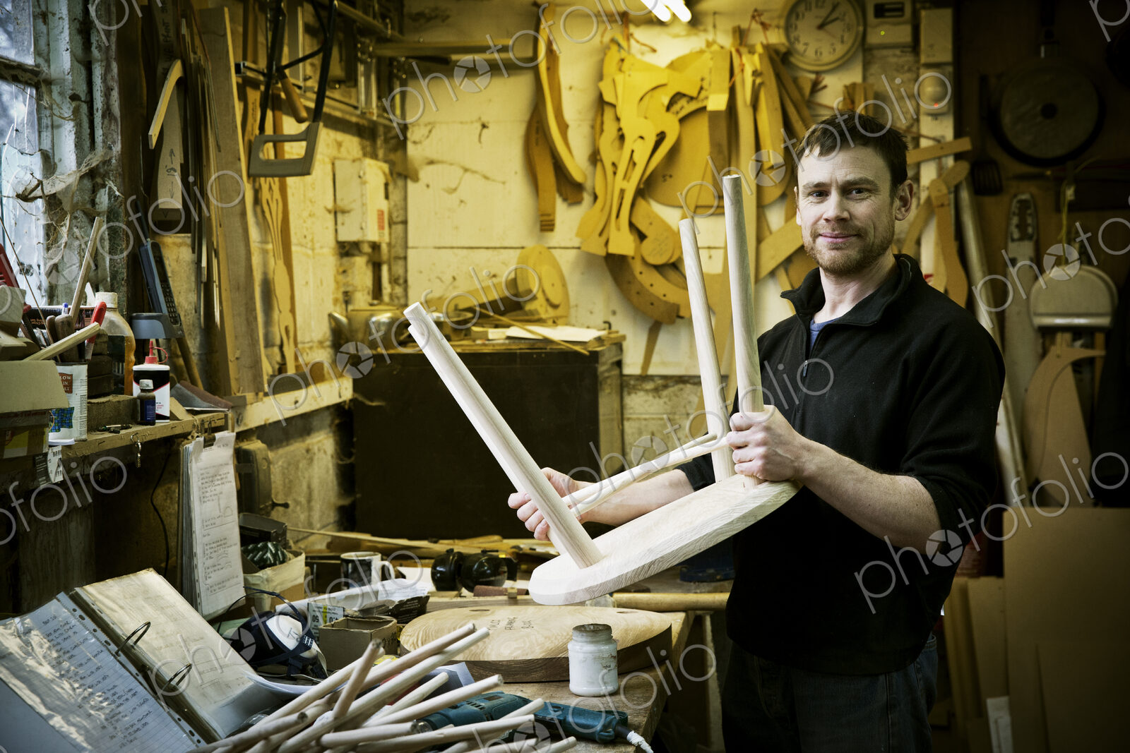 A man working in a furniture maker’s workshop. Windsor chairs.