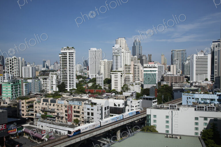 A mass transit train passes through Bangkok downtown business district.