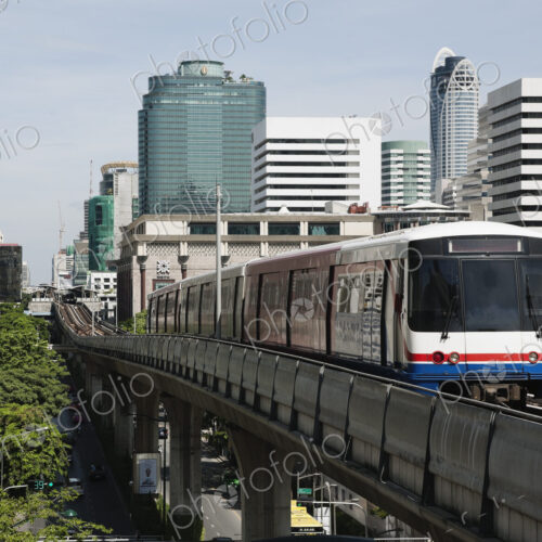A mass transit train travelling on an elevated railway line across the city of Bangkok.