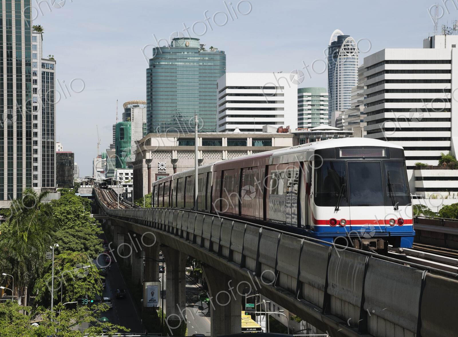 A mass transit train travelling on an elevated railway line across the city of Bangkok.