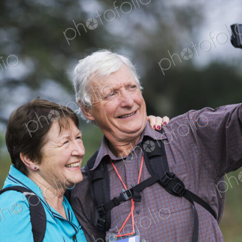 A mature couple taking a selfy photograph while out walking. A mature couple taking a selfy photograph while out walking.