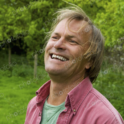A mature man in casual clothes with blonde hair, smiling broadly. A mature man in casual clothes with blonde hair, smiling broadly.