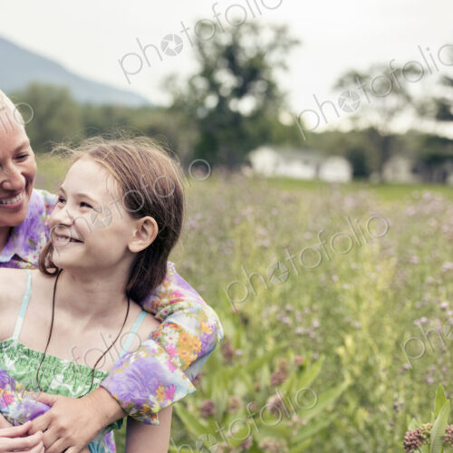 A mature woman and a young girl in a wildflower meadow. A mature woman and a young girl in a wildflower meadow.