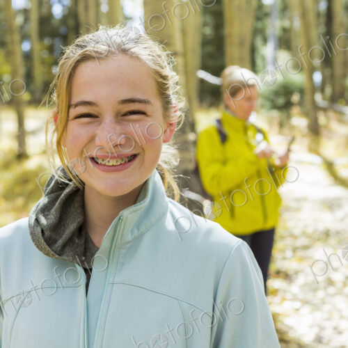 A mature woman, boy and girl, a mother and her two children in woodland, aspen trees… A mature woman, boy and girl, a mother and her two children in woodland, aspen trees…