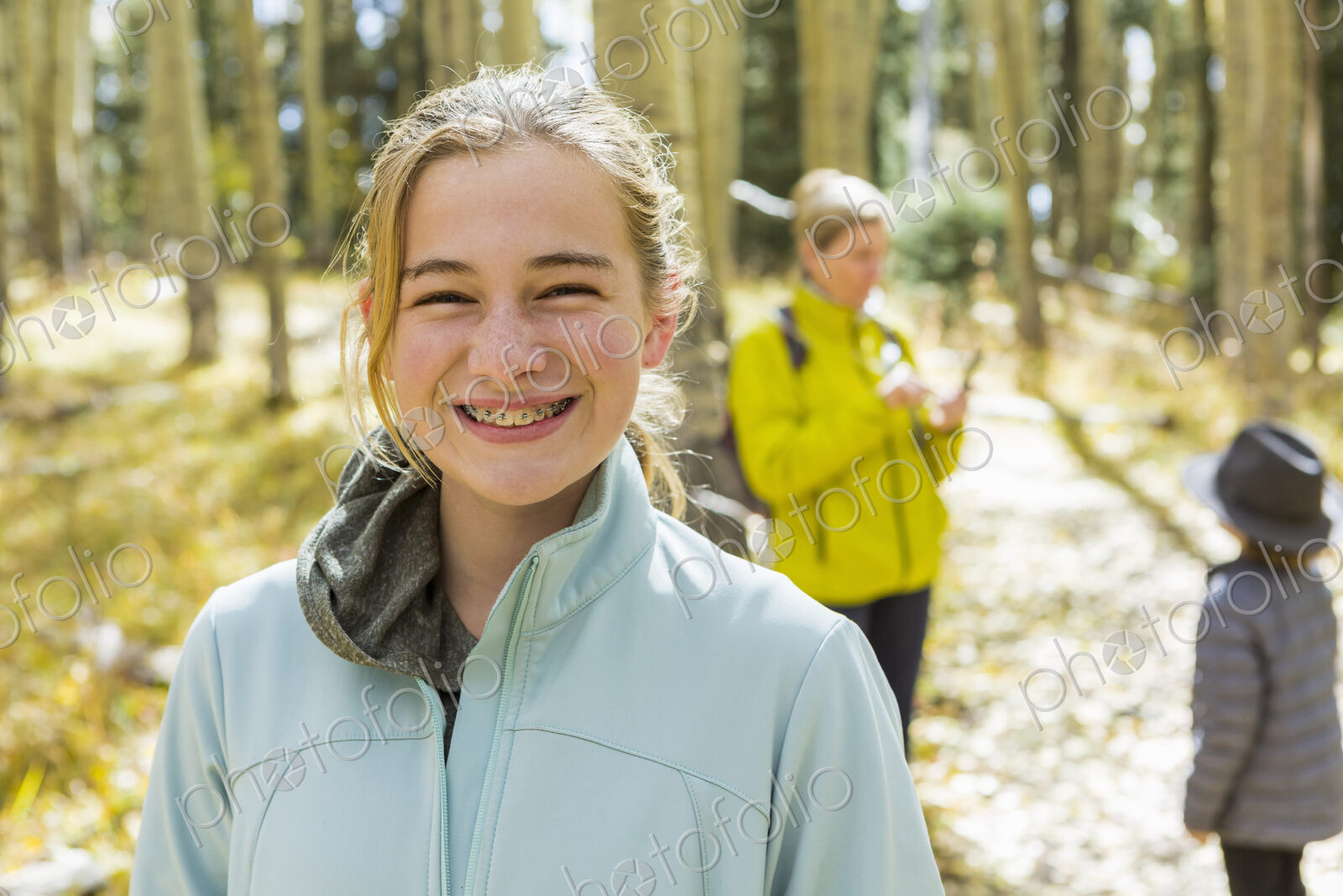 A mature woman, boy and girl, a mother and her two children in woodland, aspen trees…