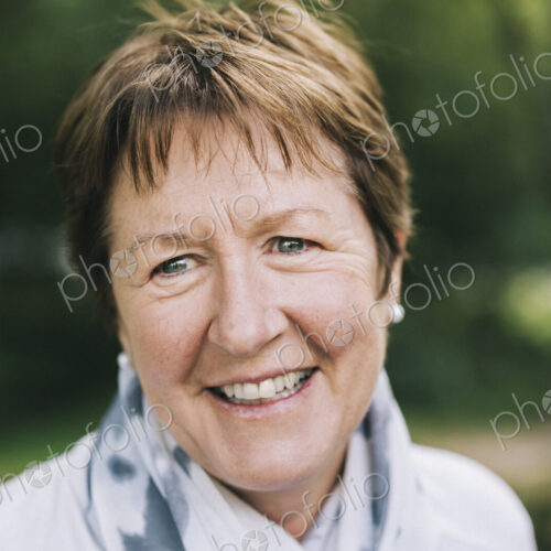 A mature woman with short brown hair smiling. A mature woman with short brown hair smiling.