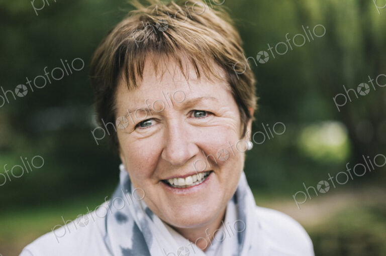 A mature woman with short brown hair smiling.