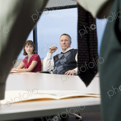 A meeting in progress in a conference room. A meeting in progress in a conference room.