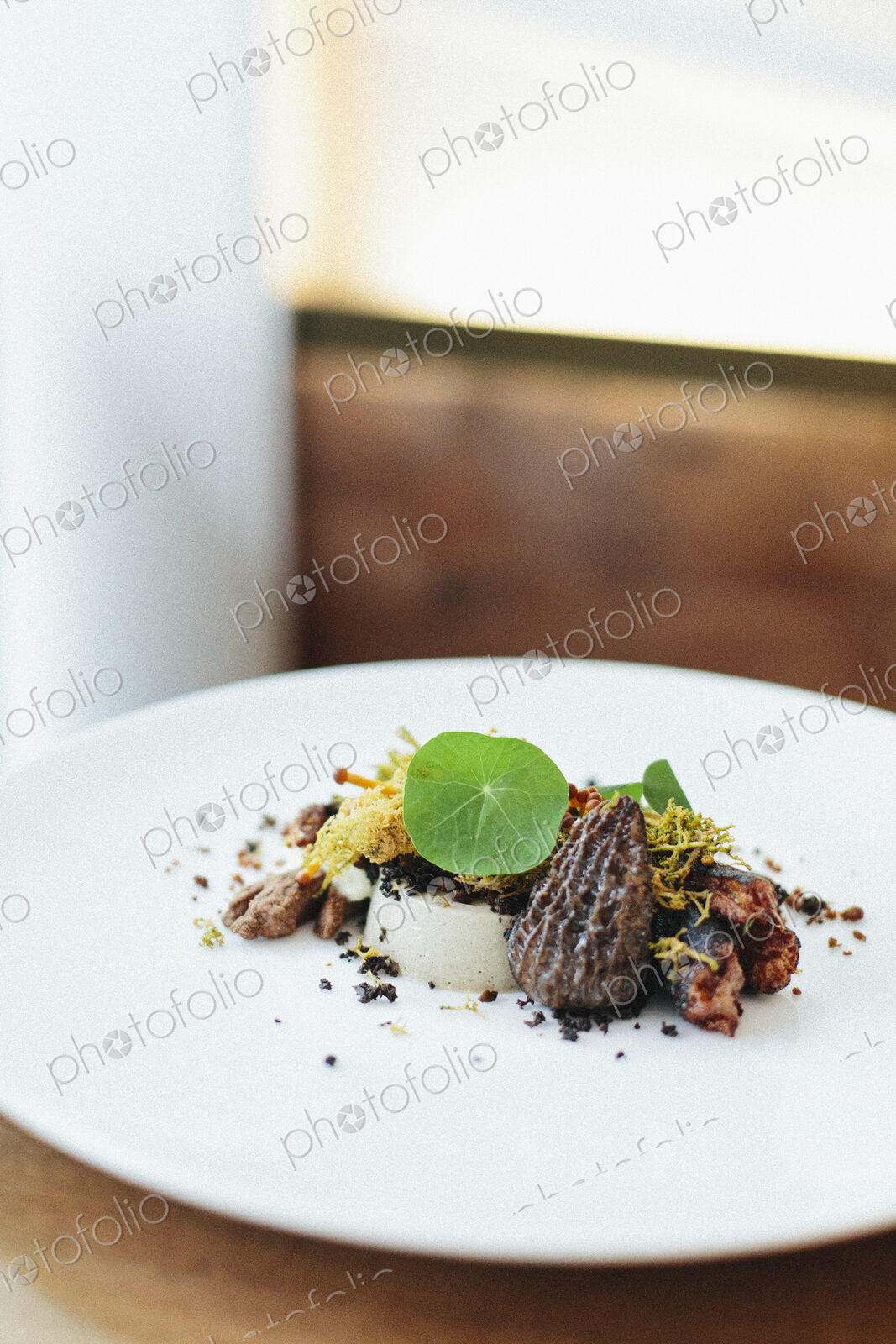 A menu dish at a city restaurant, seafood, vegetables and fresh leaves