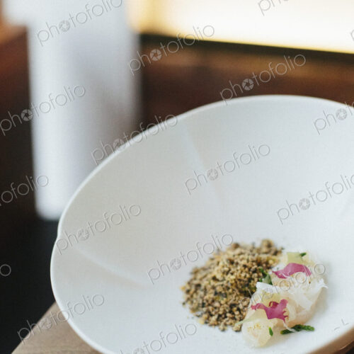 A menu dish served in a white bowl in a restaurant