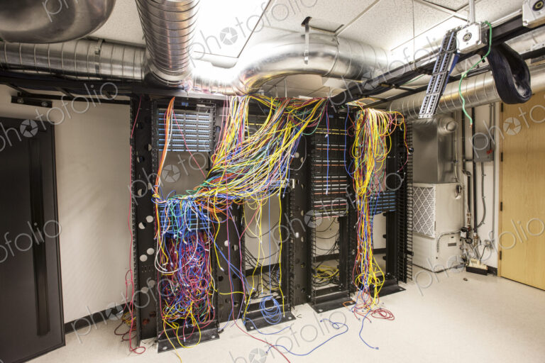 A mess of Cat 5 cables in an office server room.