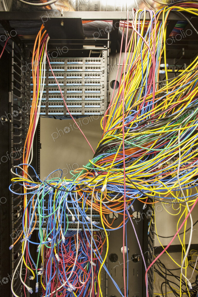 A mess of Cat 5 cables in an office server room.