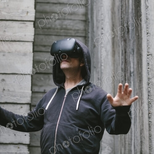 A middle aged man wearing a virtual reality headset. A middle aged man wearing a virtual reality headset.