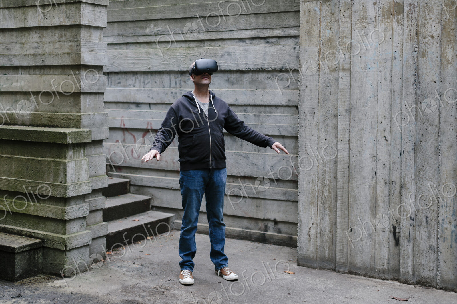 A middle aged man wearing a virtual reality headset.