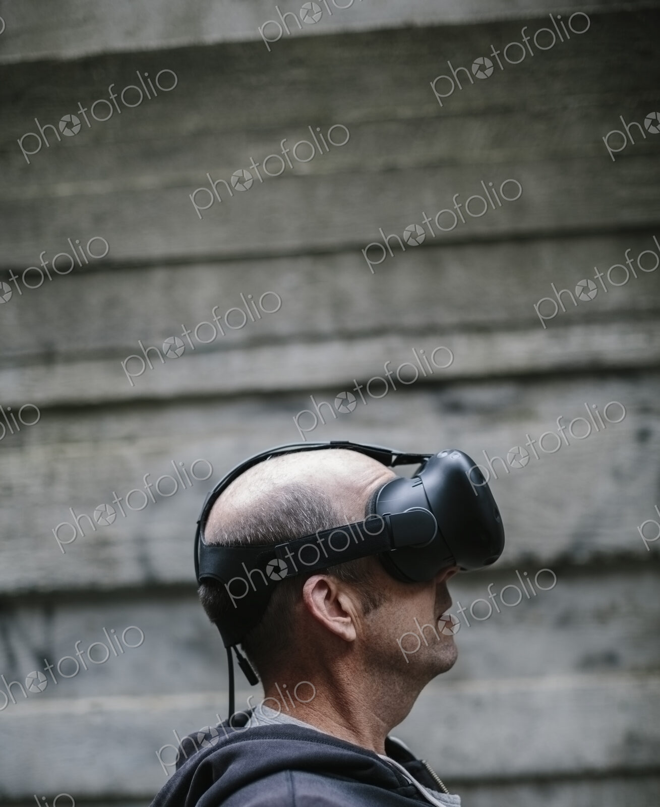 A middle aged man wearing a virtual reality headset.
