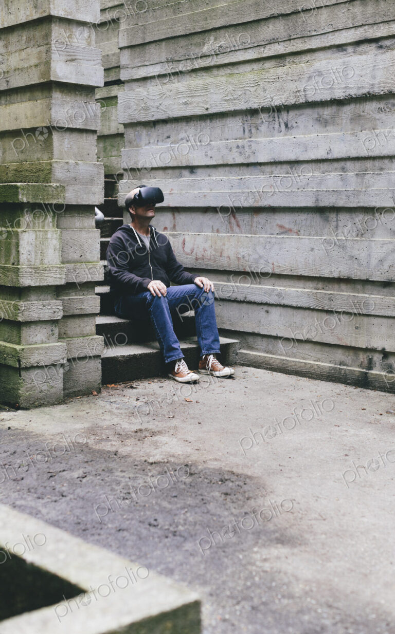 A middle aged man wearing a virtual reality headset.