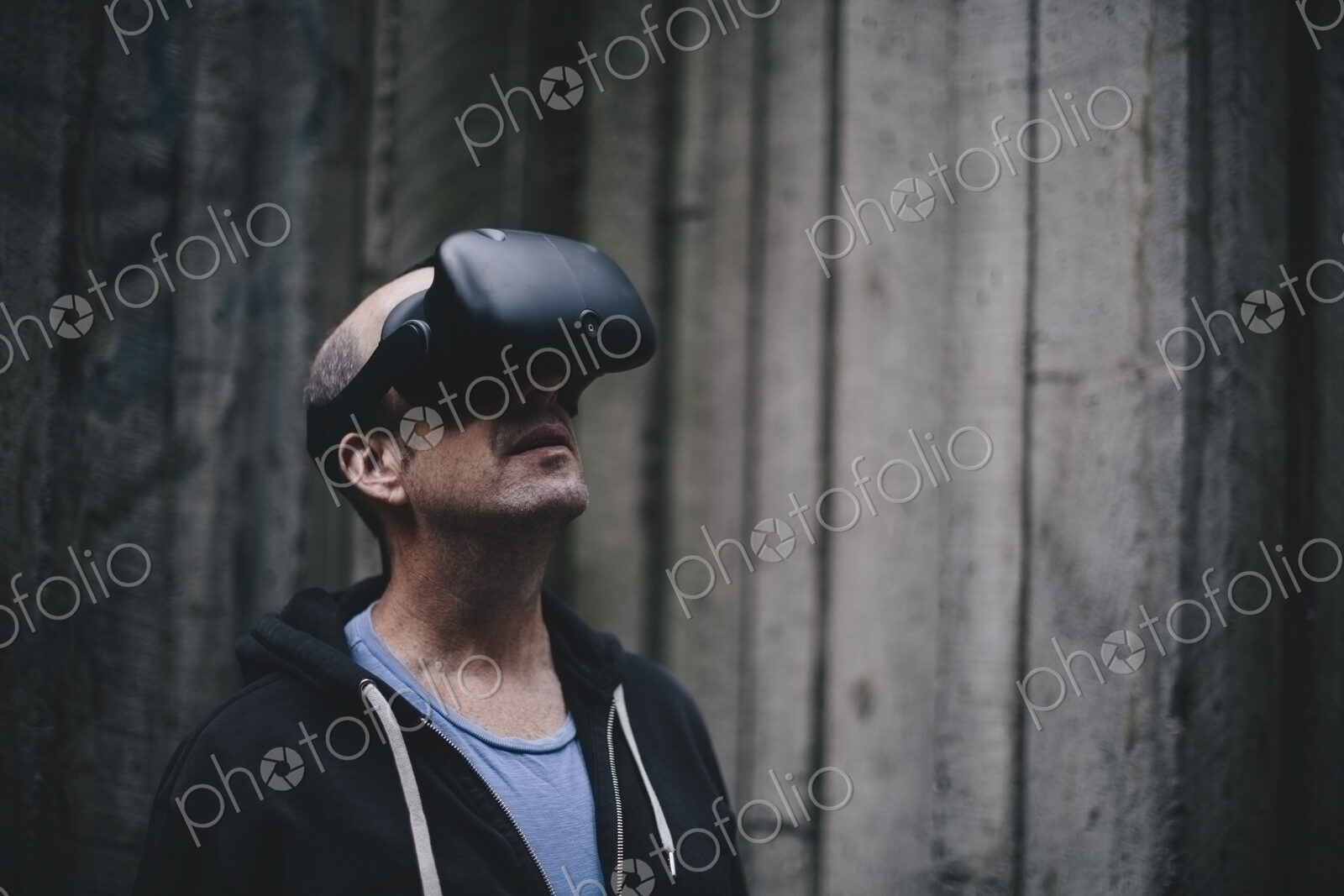 A middle aged man wearing a virtual reality headset.