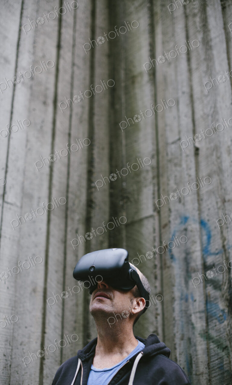A middle aged man wearing a virtual reality headset.
