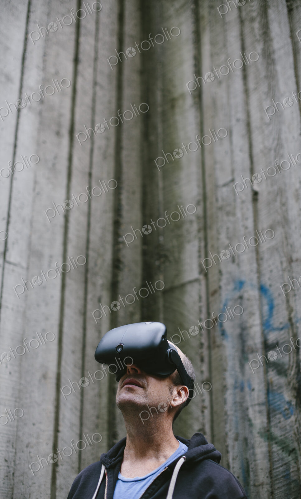 A middle aged man wearing a virtual reality headset.