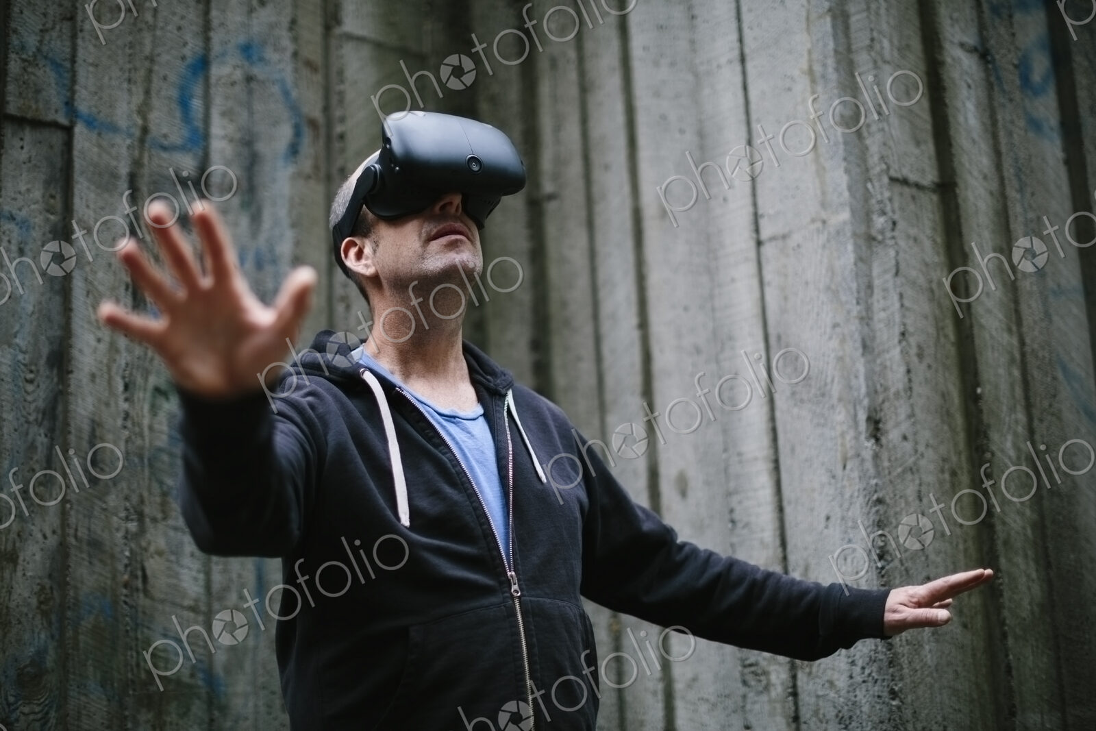 A middle aged man wearing a virtual reality headset.