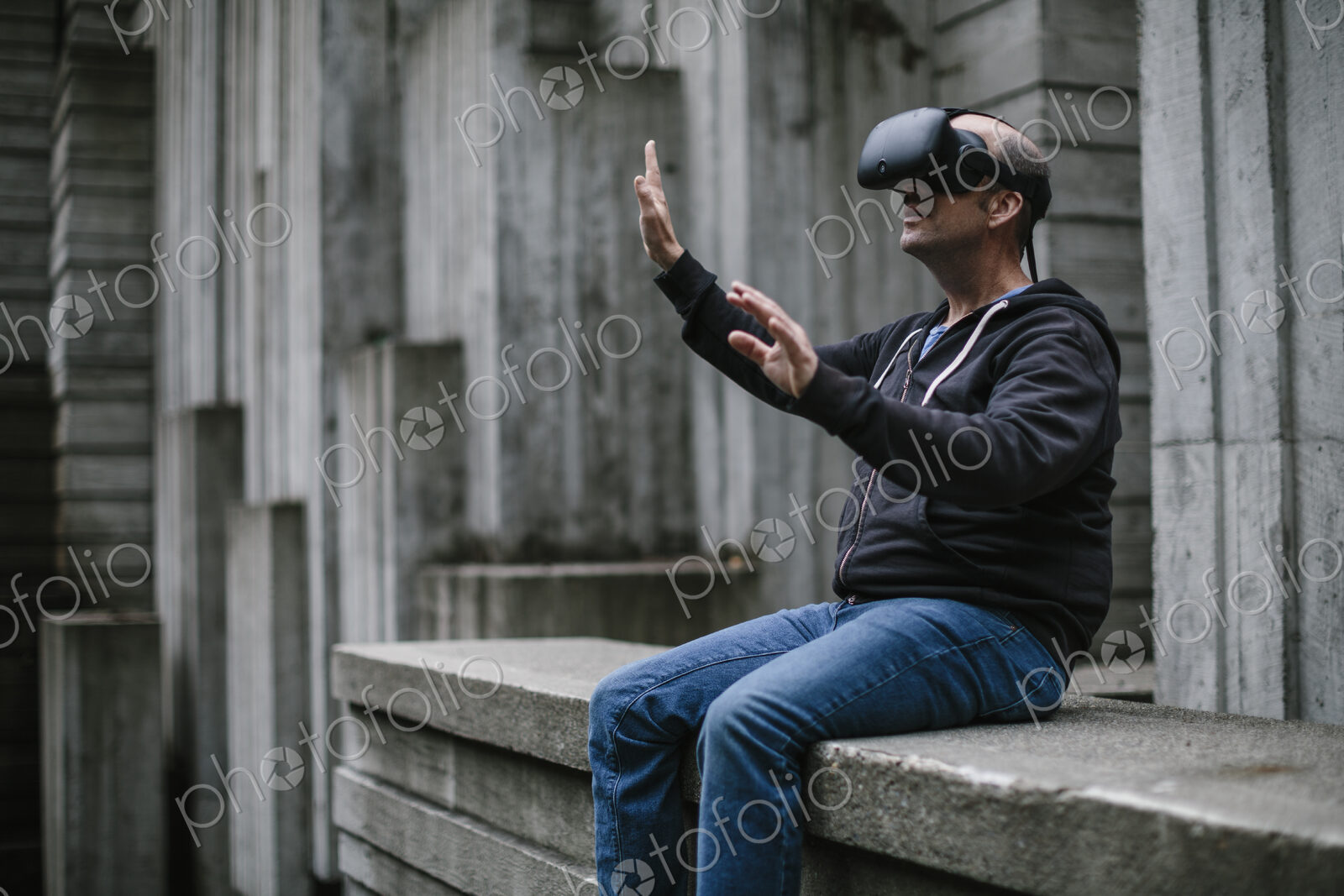 A middle aged man wearing a virtual reality headset.