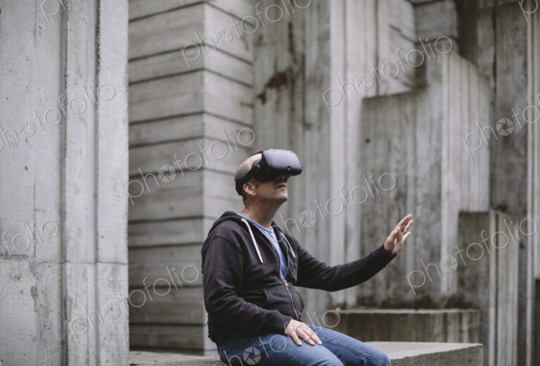 A middle aged man wearing a virtual reality headset.