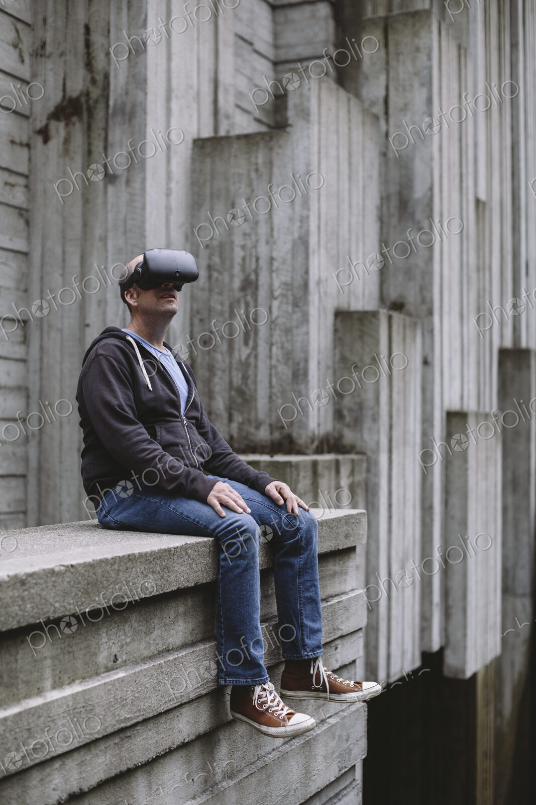 A middle aged man wearing a virtual reality headset.