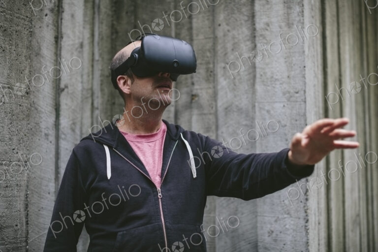 A middle aged man wearing a virtual reality headset.