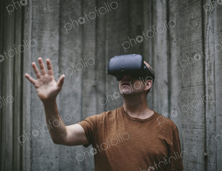A middle aged man wearing a virtual reality headset.