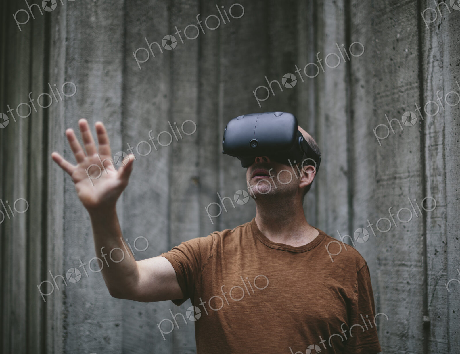 A middle aged man wearing a virtual reality headset.