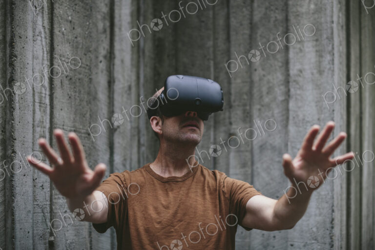 A middle aged man wearing a virtual reality headset.