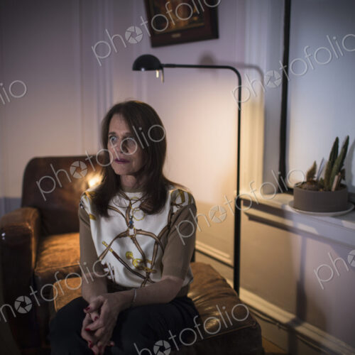 A middle aged woman seated with a sad expression. A middle aged woman seated with a sad expression.