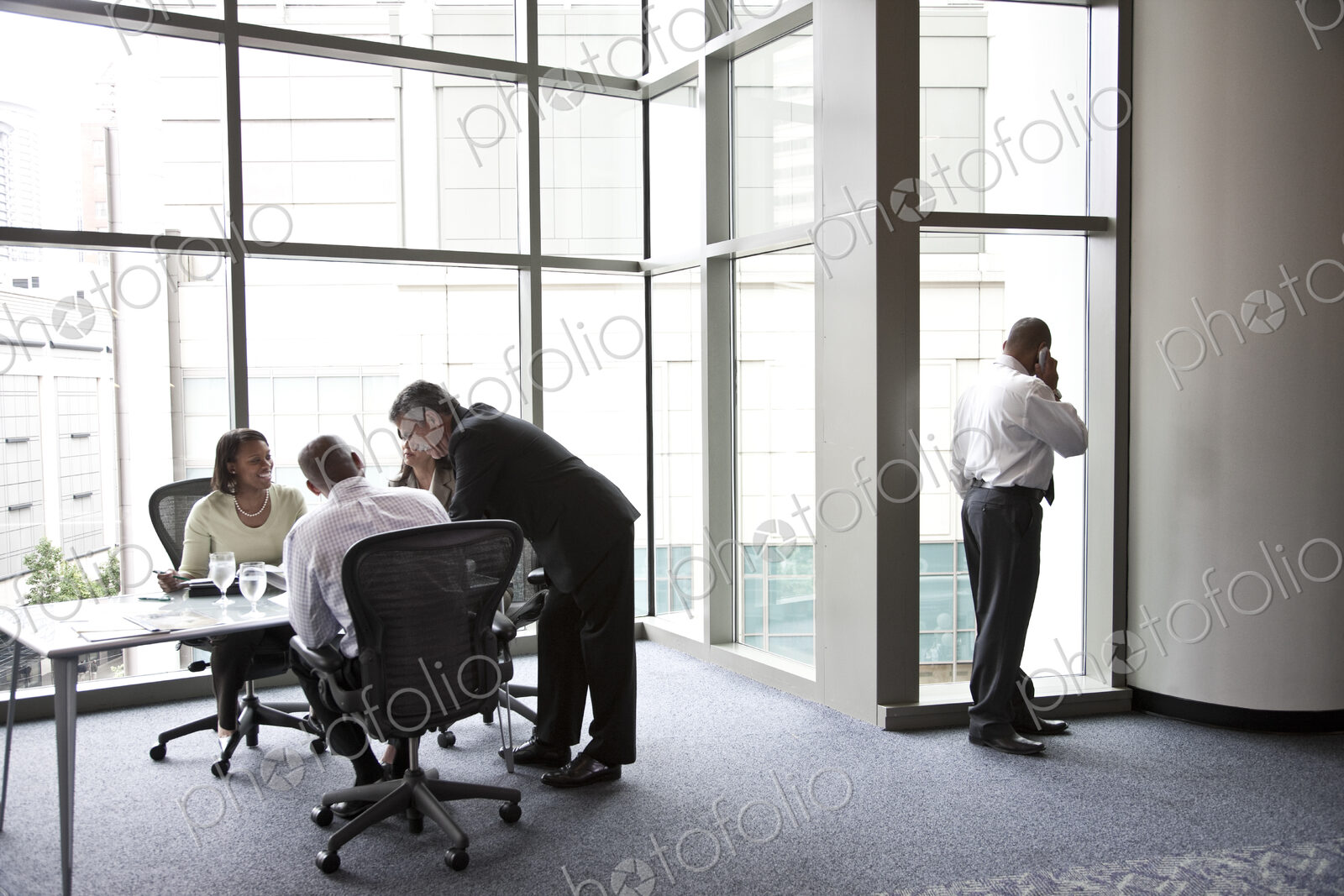 A middle eastern businessman on the phone during a meeting.