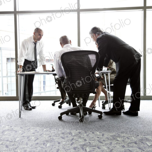 A mixed race group of male and female business people in a meeting A mixed race group of male and female business people in a meeting