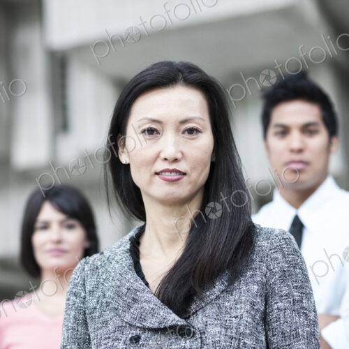 A mixed race team of business people with an Asian businesswoman in the lead. A mixed race team of business people with an Asian businesswoman in the lead.