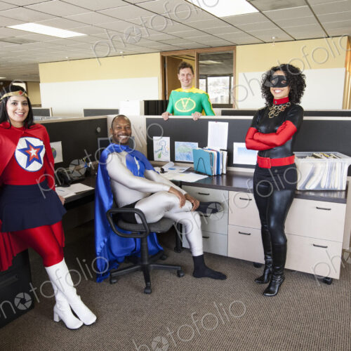A mixed race team of office super hero's in thier office. A mixed race team of office super hero's in thier office.