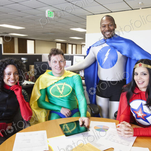 A mixed race team of office super hero's in thier office. A mixed race team of office super hero's in thier office.
