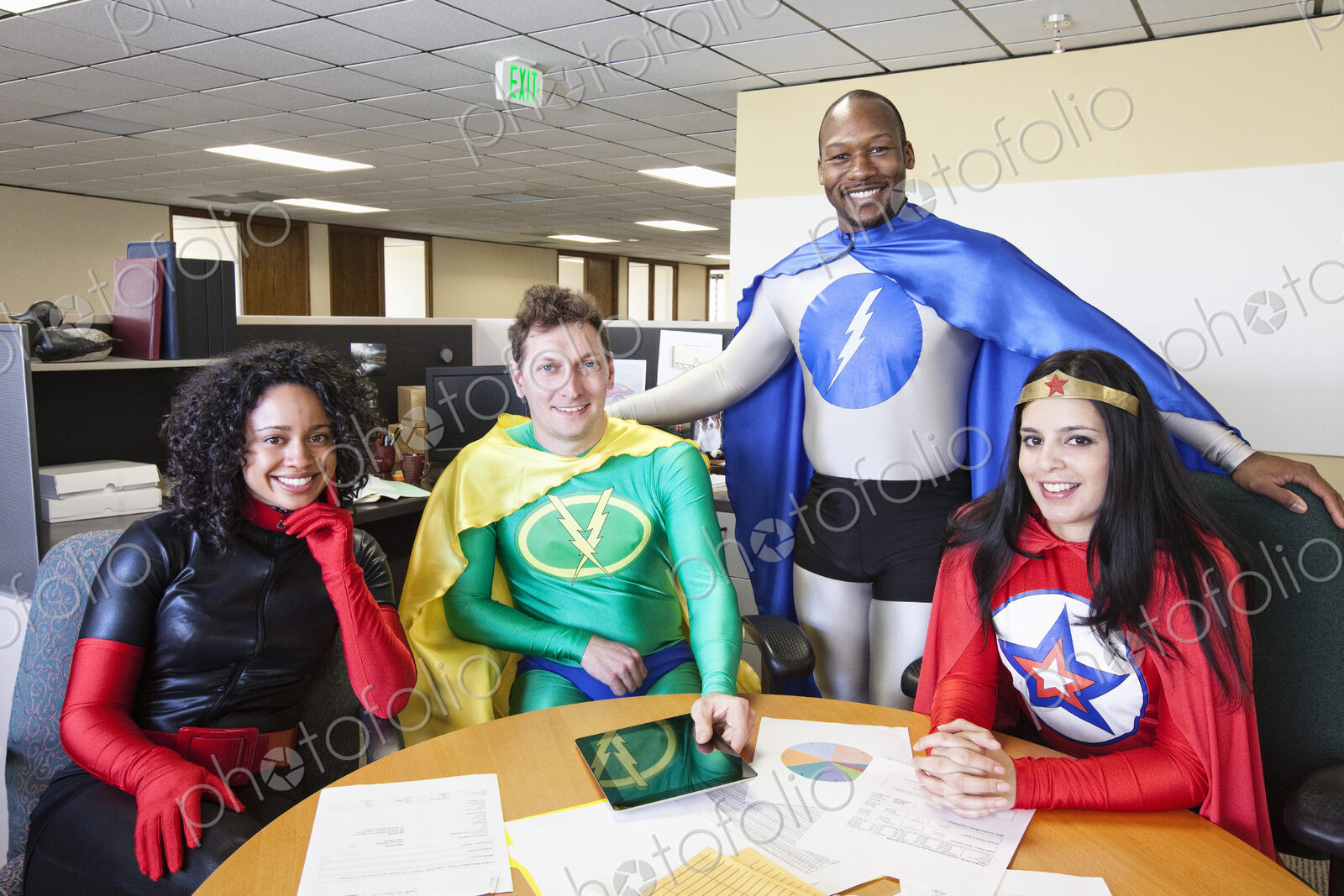 A mixed race team of office super hero’s in their office.