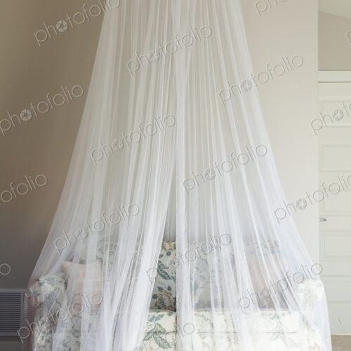 A mosquito net draped over a sofa. A mosquito net draped over a sofa.