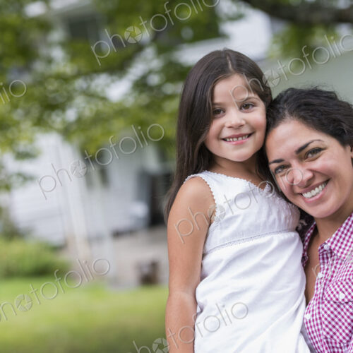 A mother and daughter in a country garden.