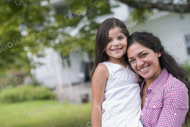 A mother and daughter in a country garden.