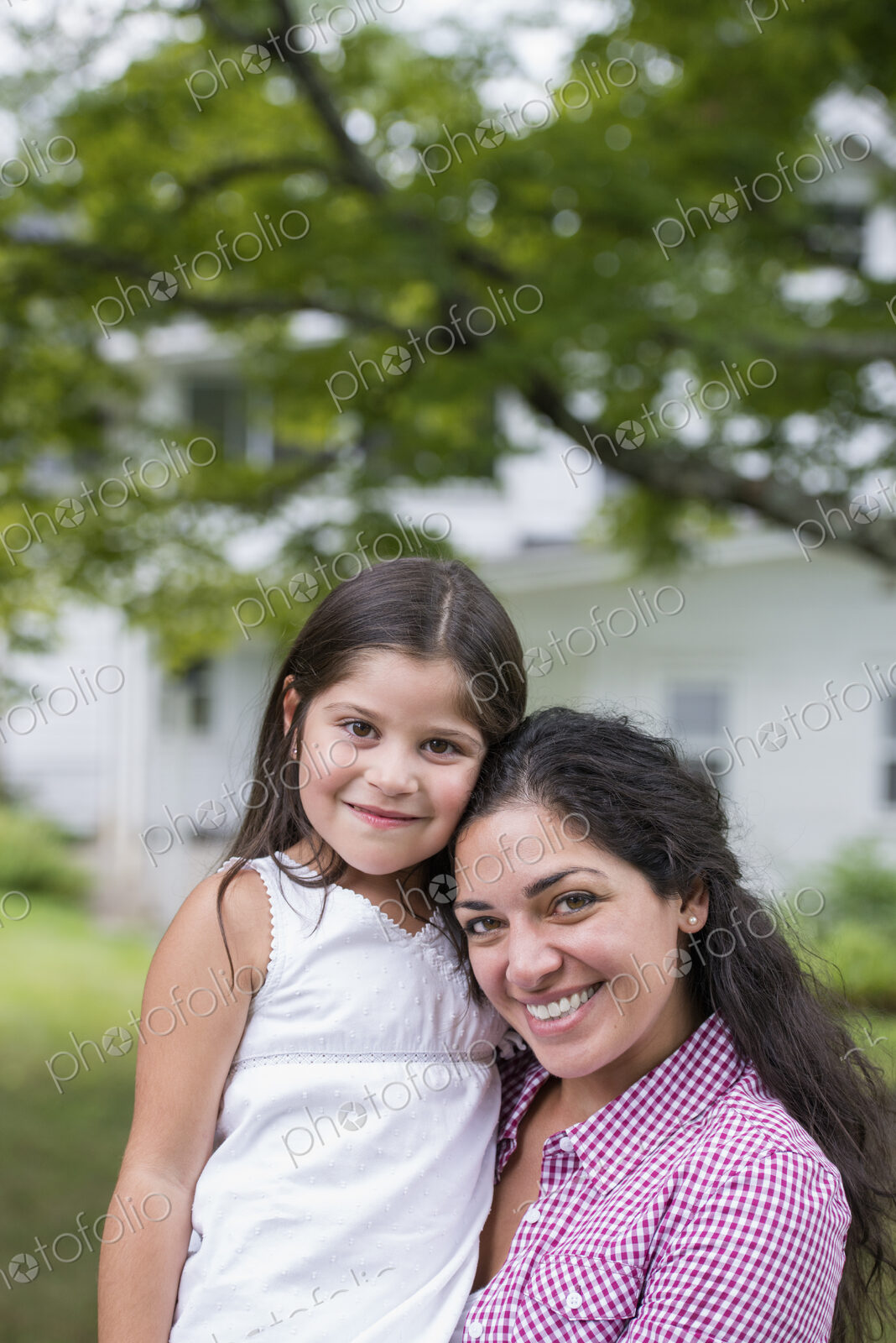A mother and daughter in a country garden.