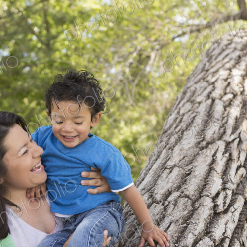 A mother and son in the park in Santa Fe, by a tall tree. A mother and son in the park in Santa Fe, by a tall tree.